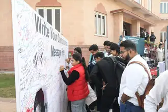 Students writing messages for Saurabh Jain at the festival